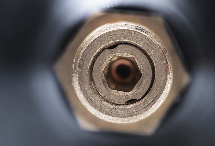 Close-up front view of a hexagonal opening in a metal component.